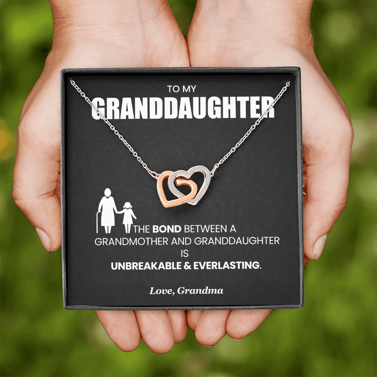 "Gift box with interlocking hearts necklace and message card celebrating bond between Grandma and Granddaughter"