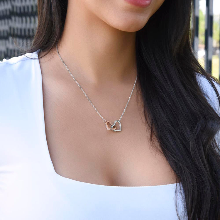 "Granddaughter wearing interlocking hearts necklace with rose gold and silver finish"