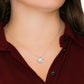 “To My Daughter-in-Law Love Knot Necklace with cubic zirconia pendant on adjustable silver chain, worn by woman in red blouse – elegant jewelry gift”