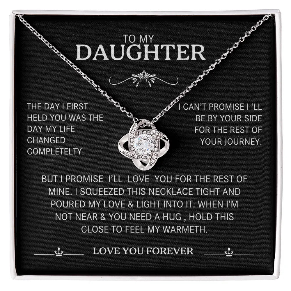 Necklace with sentimental message card for daughter on a black background