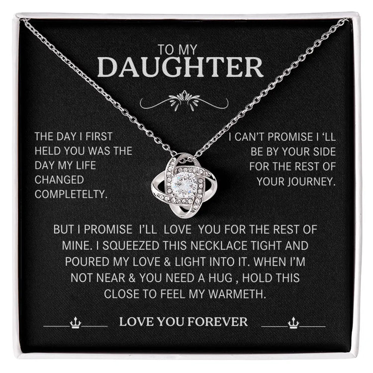 Necklace with sentimental message card for daughter on a black background