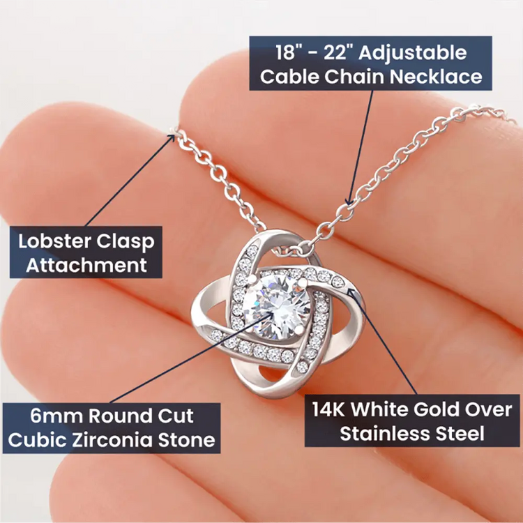 Necklace with lobster clasp and cubic zirconia stone held in hand, labeled with features.