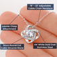 Necklace with lobster clasp and cubic zirconia stone held in hand, labeled with features.