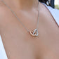 Model wearing 14k white gold interlocking hearts pendant necklace gift